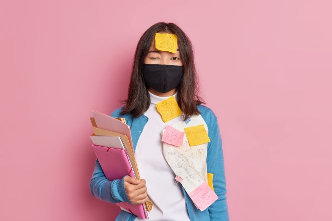 prevention-virus-spread-serious-brunette-woman-wears-black-disposable-face-mask-busy-doing-tasks-makes-notes-remember-mathematical-formulas