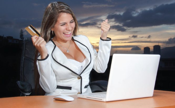 woman laughing in front of laptop