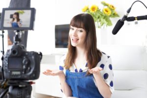 female-vlogger-recording-broadcast-home